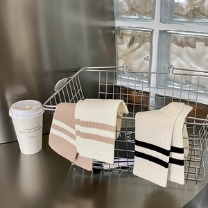 Detailed texture of combed cotton mid-calf socks with classic stripes in a metal basket