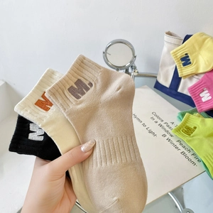Colorful combed cotton ankle socks with M letter embroidery shown in a group set
