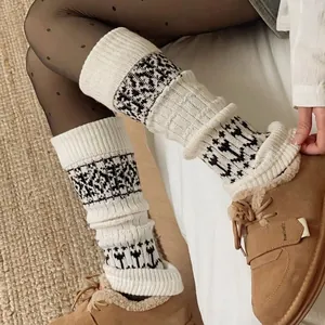Fair Isle knitted leg warmers in cream white with black geometric jacquard patterns