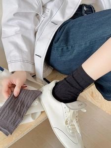 Detailed texture of vertical ribbed knit cotton socks in black and grey mix