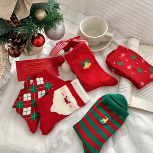 Cozy Christmas themed cotton socks gift set with festive patterns on white background
