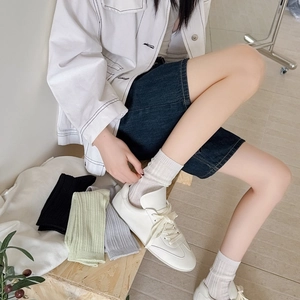 Detailed knit texture of breathable mesh crew socks in white, black, green and grey