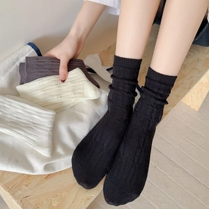 Women's vertical knit crew socks in black and white with breathable mesh pattern