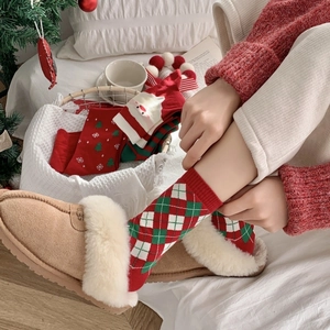 Christmas socks set in red and green with festive patterns and warm cozy home atmosphere
