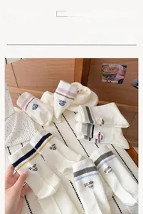 Detail of cotton crew socks with colorful stripes and Delight 2050 embroidery lettering