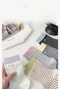 Detail of colorful striped cotton crew socks with handmade labels in a cozy layout
