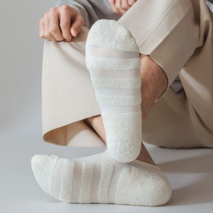 Detail of cream white invisible cotton socks featuring thick striped terry fabric texture