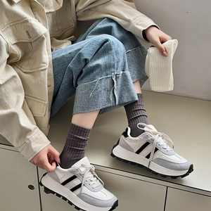 Women's minimalist white and grey platform sneakers with black stripes and thick sole
