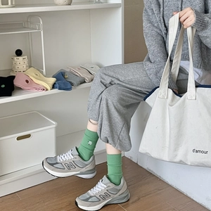 Detail of ribbed grass green crew socks with sheep embroidery and colorful options