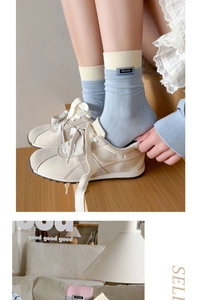 Detail of ribbed knit cotton socks in blue and beige with Amity fabric label