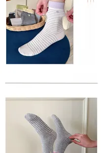 Detail of color-block striped cotton mid-calf socks with ribbed cuffs and elastic fabric