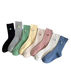 Eight pairs of ribbed cotton crew socks in pastel colors with cute emoji embroidery