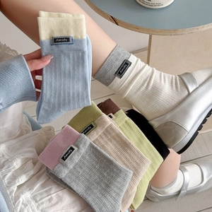 Breathable cotton slouch socks set in multiple colors with knit texture and fabric labels