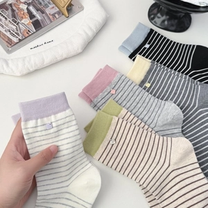 Women's cotton crew socks with striped patterns and handmade metal pendant detail