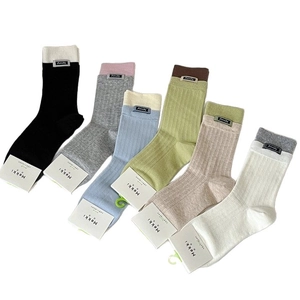 Set of six colorful ribbed cotton mid-calf socks with Amity tags in minimalist style
