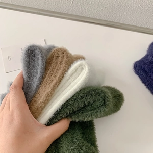Close-up of thick mink velvet socks showing soft fluffy texture and multiple colors
