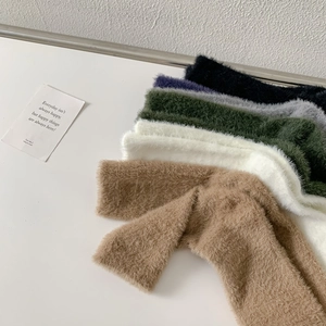 Macro view showing a variety of colorful fluffy mink velvet socks with soft texture