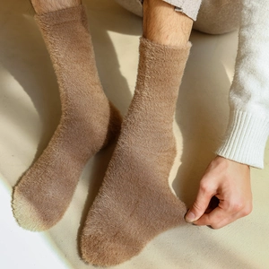 Close-up of thick brown mink velvet socks showing elastic stretch and soft plush texture