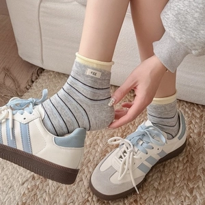 Colorful striped combed cotton socks with egg label and yellow rolled edge cuff detail