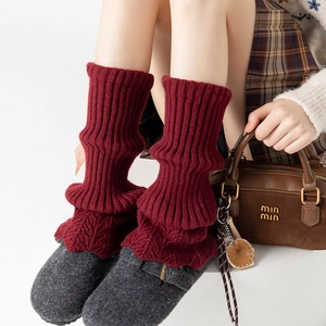 Knitted leg warmers in wine red color featuring vertical stripes for winter comfort