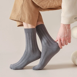 Close-up of grey ribbed business socks for men showing vertical texture and fabric detail