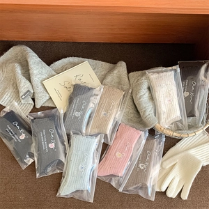 Detail of colorful knitted wool socks in zipper packaging with a warm lifestyle setting