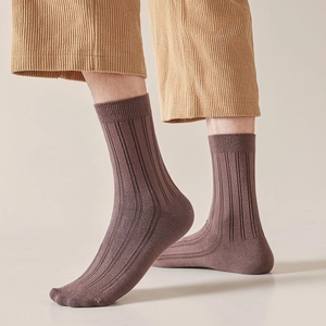 Close-up of ribbed texture and elastic cuff on men's cotton crew socks in brown