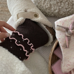 Cozy wool crew socks with pink ruffled cuffs, white dots, and sweet bow details for winter