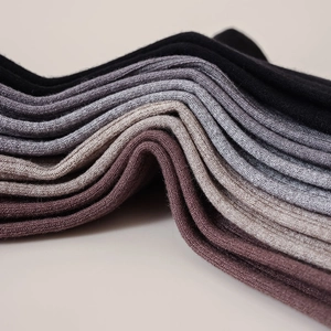 Close-up of ribbed knit texture on men's cotton business socks in assorted neutral tones