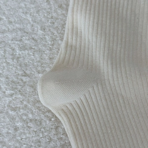 Close-up of cream ribbed knit socks showing the heel craftsmanship and texture