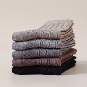 Detail of five pairs of ribbed cotton socks in autumn colors showing knit texture