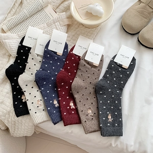 Detailed view of six-pair wool blend socks set featuring polka dots and dog embroidery