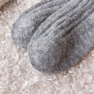 Detailed macro view showing the high-quality gray knitted wool texture on the toe area