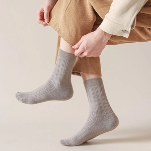 Close-up of oatmeal ribbed cotton crew socks showing soft texture and elastic cuff