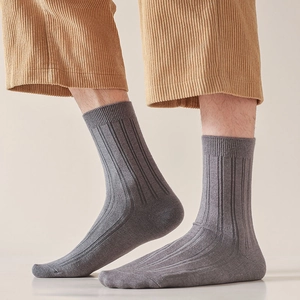 Men's grey ribbed cotton business socks in minimalist Japanese style shown with corduroy pants