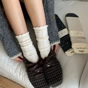 Three-pack vintage wool crew socks with polka dots and frill cuffs on sofa