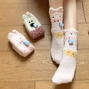 Detail of coral fleece thick warm socks with cute cartoon pig and bear designs