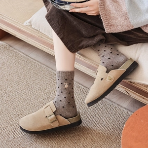 Beige suede mules and cute embroidered deer wool socks for a warm winter aesthetic