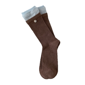 Brown knit crew socks with light blue striped cuffs and white button details