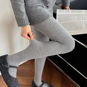 Detail of high-elasticity grey vertical stripe wool leggings showing stretch performance