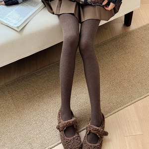Detailed knit texture of dark coffee vertical striped wool leggings with Mary Jane shoes