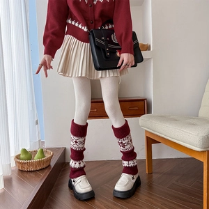 Ethnic knit leg warmers featuring red and white snowflake patterns for winter fashion