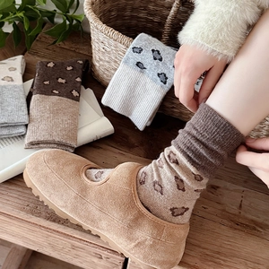 Close-up of vintage leopard print thick knit socks with warm ribbed texture detail