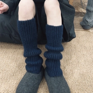 Deep blue ribbed knit leg warmers for winter boots with a soft slouchy texture
