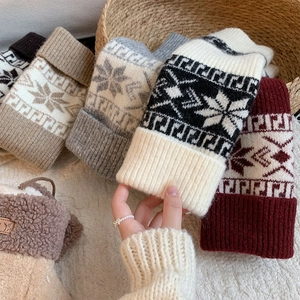 Detail of grey winter leg warmers featuring snowflake knit pattern and ribbed cuffs
