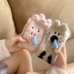 Close-up of soft coral fleece socks with cute cartoon pig face and 3D blue droplet detail