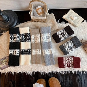 Detailed flat lay of colorful vintage snowflake jacquard knit leg warmers for winter