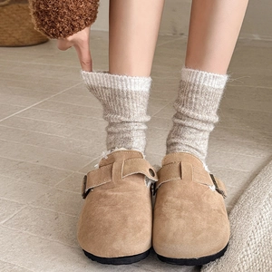 Detail of camel suede mule slippers with plush fleece lining and bronze metal buckle