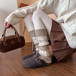 Detailed knit pattern of vintage snowflake leg warmers with ribbed cuff in warm khaki