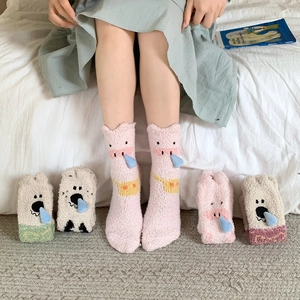 Detail of soft coral fleece winter socks featuring 3D cartoon animal designs